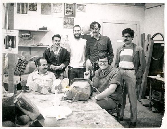 Black and white photo of group of men in art studio.