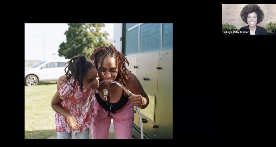 Screen shot from Zoom lecture with LaToya Ruby Frazier showing two women drinking water from a hose.