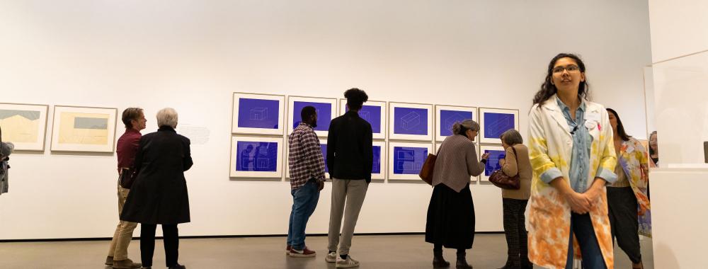 People viewing art in the museum gallery.
