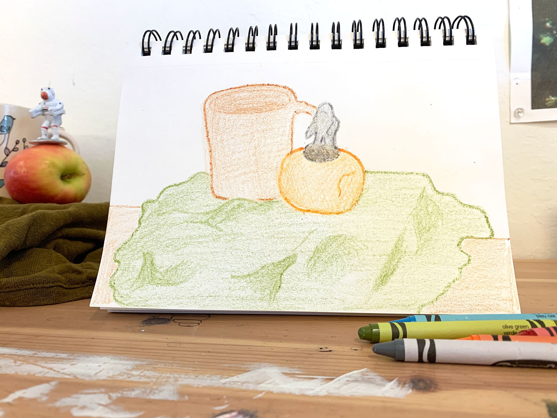 Crayon drawing of objects on paper.