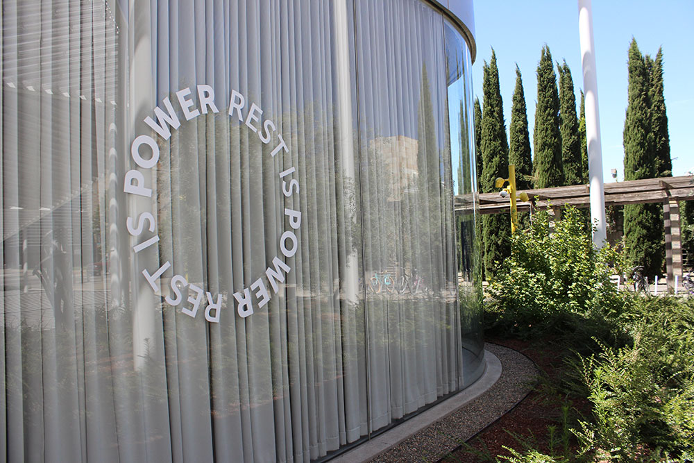 Front of the museum showing the window with round 'Rest is Power' title circle.