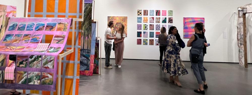 Visitors talking in the galleries during the Arts and Humanities Graduate Exhibition.