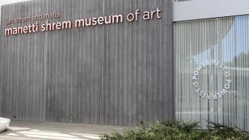 Front of the museum showing the Rest is Power circular title treatment in the window.