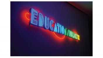 Neon artwork installed at the museum reading 'Education Should Be Free'.