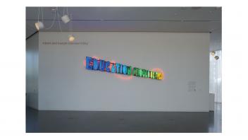 Neon artwork in the museum lobby saying 'Education Should be Free'.