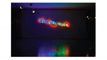 Neon artwork installed at the museum reading 'Education Should Be Free'.