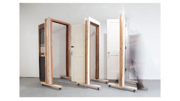 Artwork by Helia Pouynafar consisting of three door frames with doors.