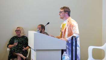 Visitor Services student speaking at an event at the museum.