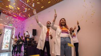 Visitor Services students throwing confetti at the museum's birthday party.