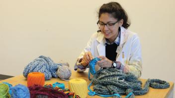 Visitor Services student knitting in the art studio.