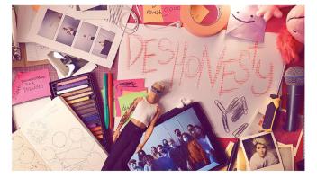 Photo of art materials, doll and photos and the word 'deshonesty'.