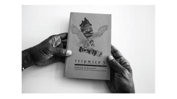 Black and white photo of hands holding a book titled 'Tripwire 5'.