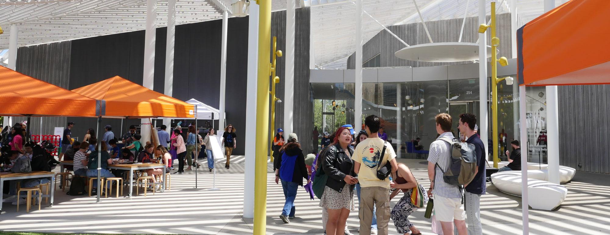 People on the plaza at the museum during Picnic Day.