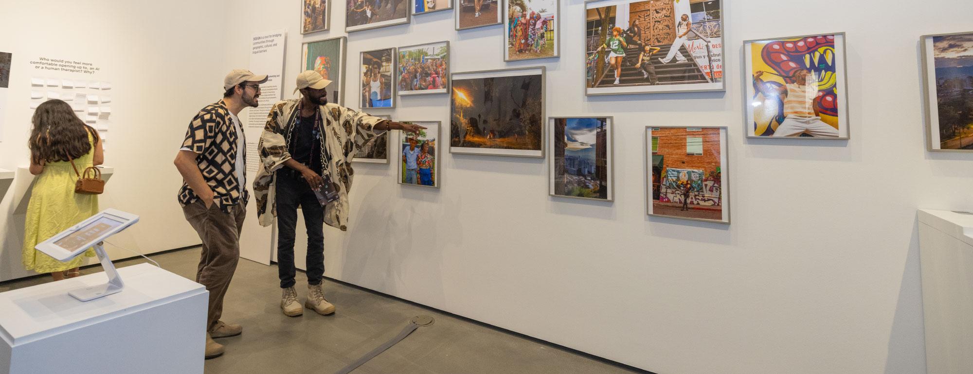People looking at photos in the galleries during the Grad Show.