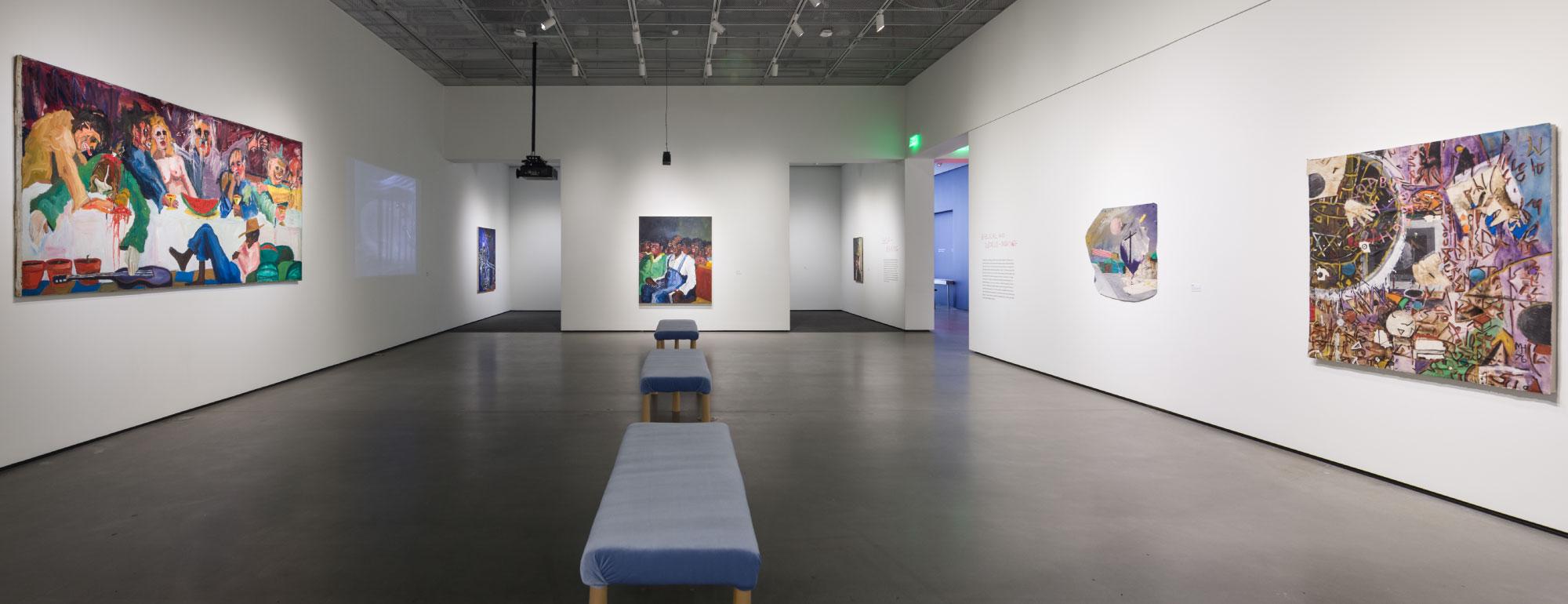 Gallery installation of Mike Henderson paintings at the museum.
