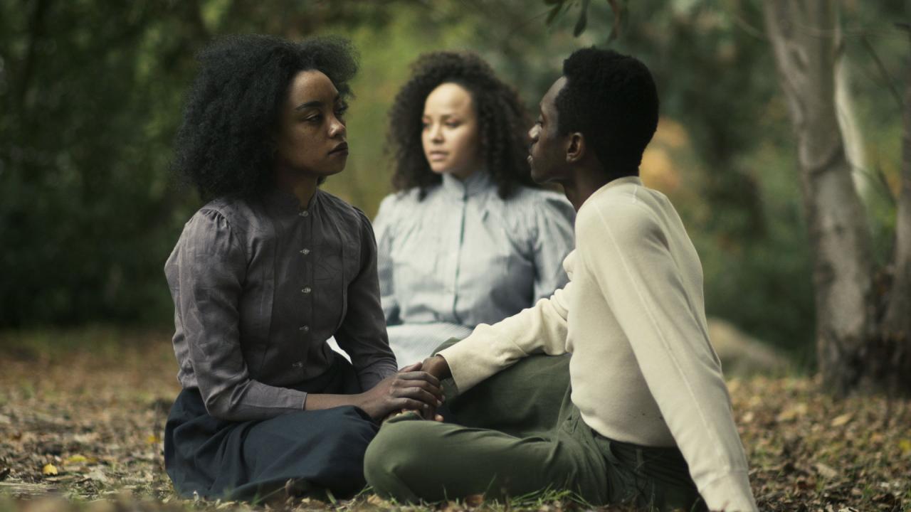 Three people sitting in a still image from Theaster Gates' 'Dance of Malaga' video.