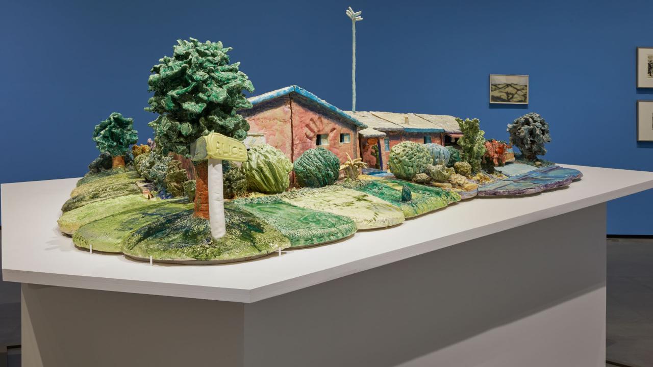 Ceramic house sculpture in the gallery.