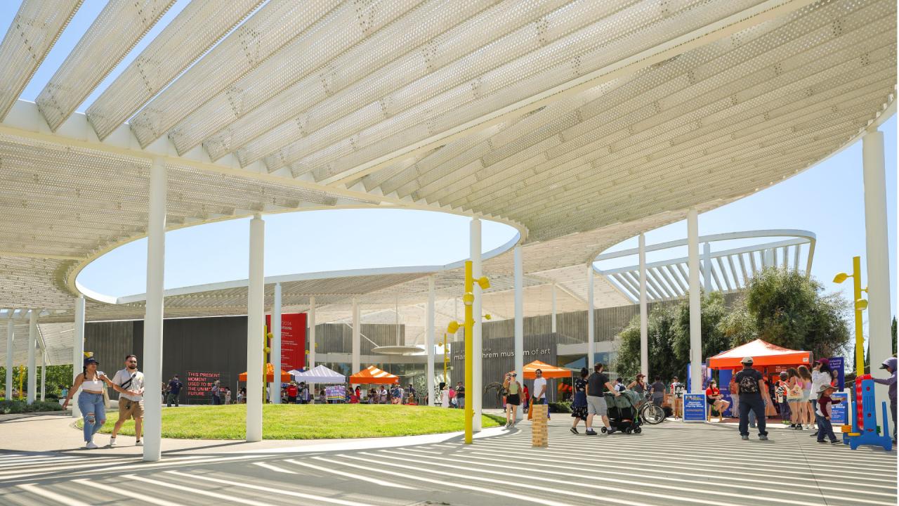 People on the event plaza in front of the museum on Picnic Day.