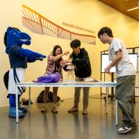 Students using materials to build sculptures at an event at the museum.