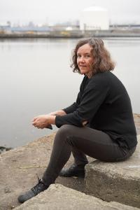 Marie Lorenz sitting by a river.