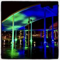 Museum plaza lit in blue and green lights at night for the annual gala.