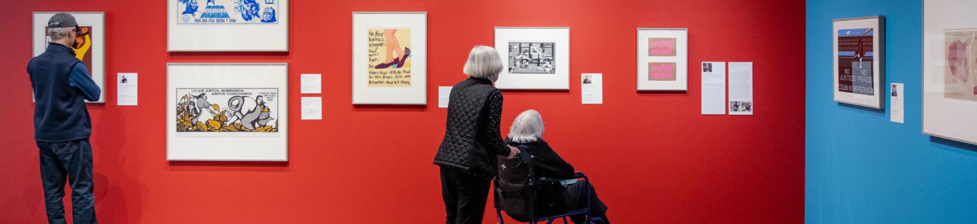 Visitors in the gallery looking at prints.