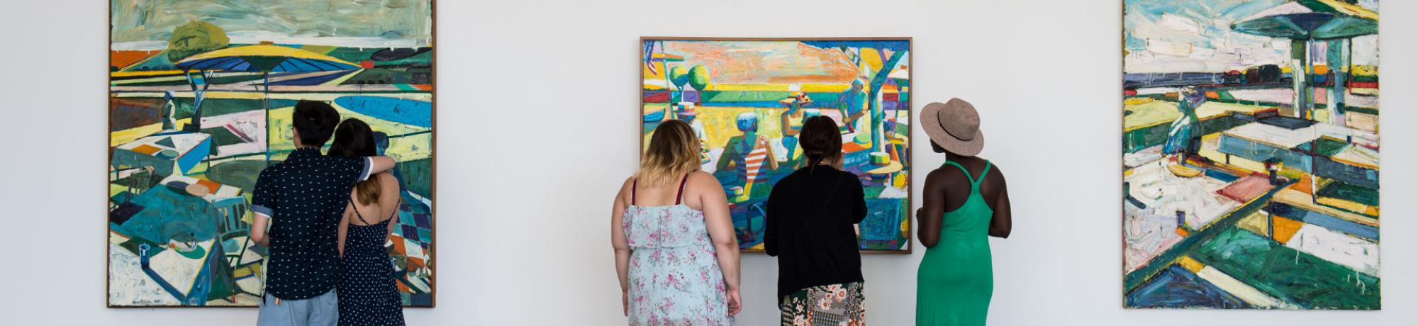 Students viewing paintings at the museum.