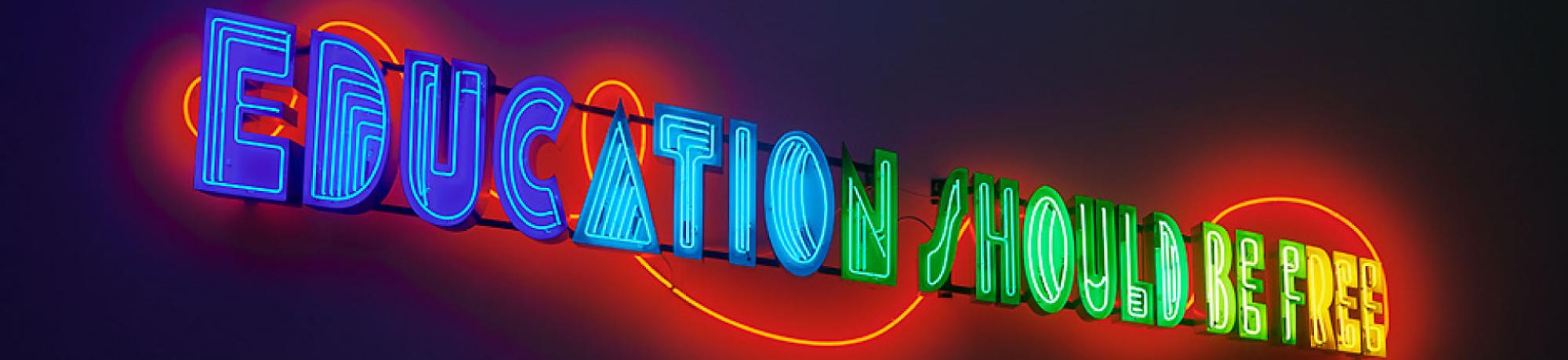 Neon artwork installed at the museum reading 'Education Should Be Free'.