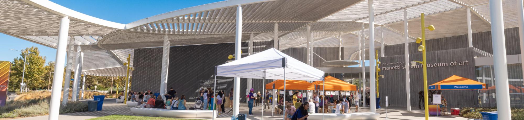 Event plaza of the museum with orange and white pop up canopies for the fall season celebration.