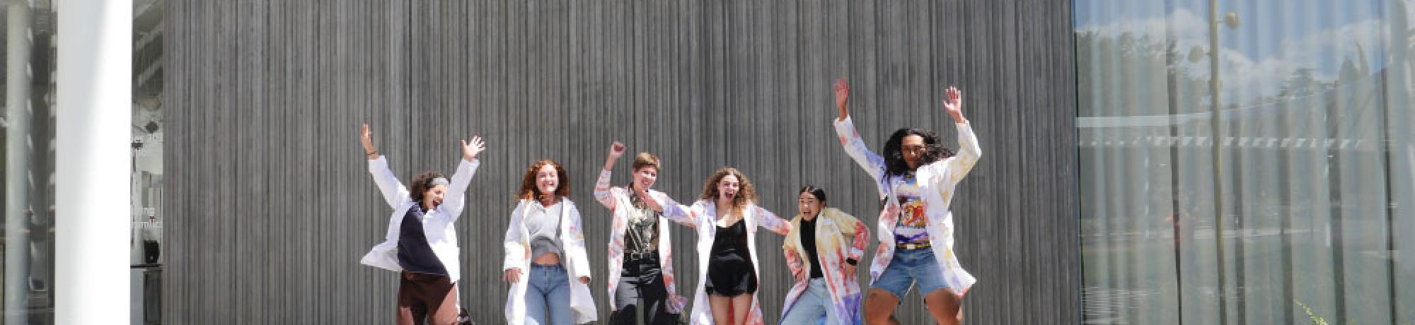 Students jumping in front of the museum.