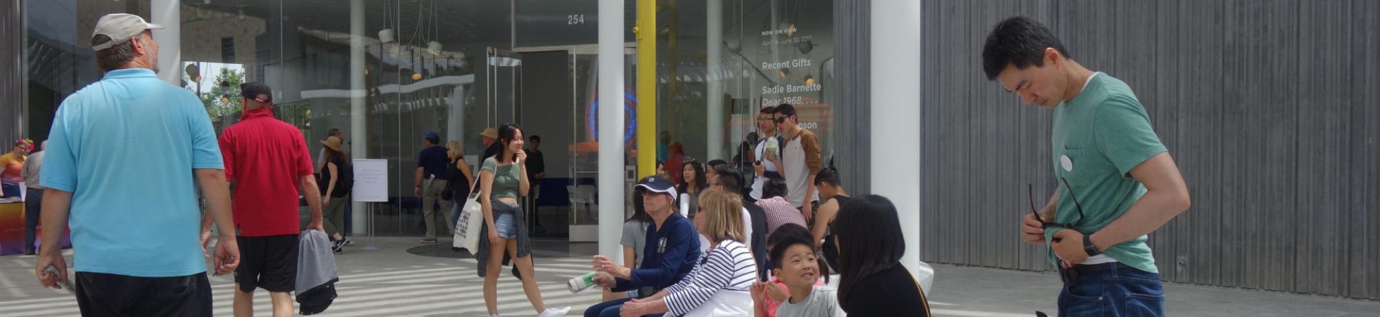 People gathered outside the museum on the plaza.