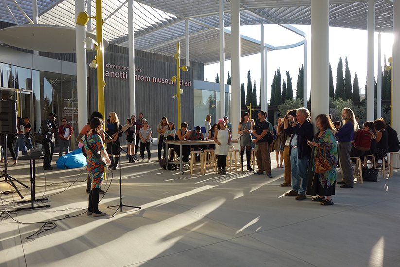 Photo of the event plaza with visitors enjoying live music