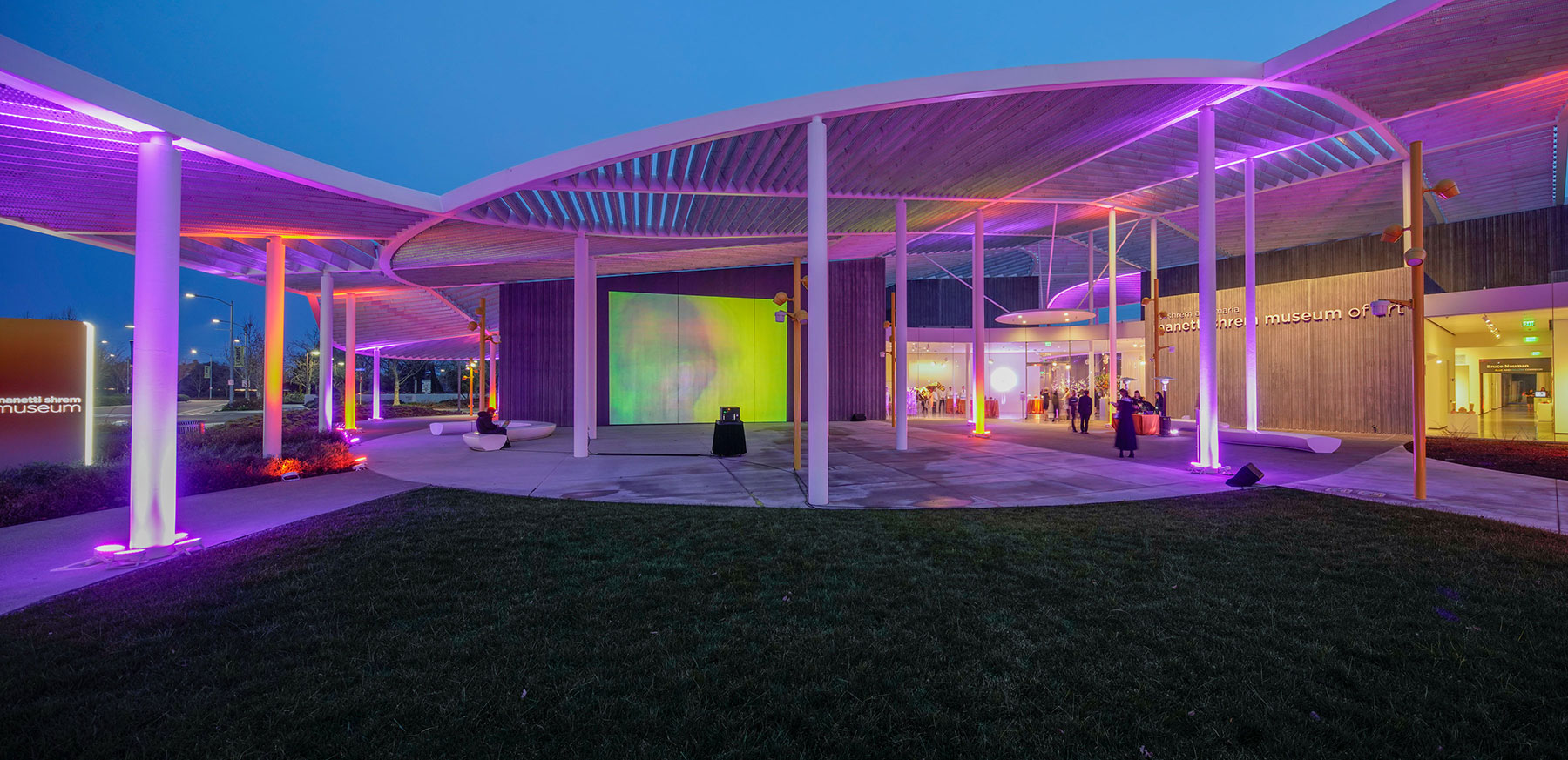 Photo of the museum event plaza lit with purple lights at night.