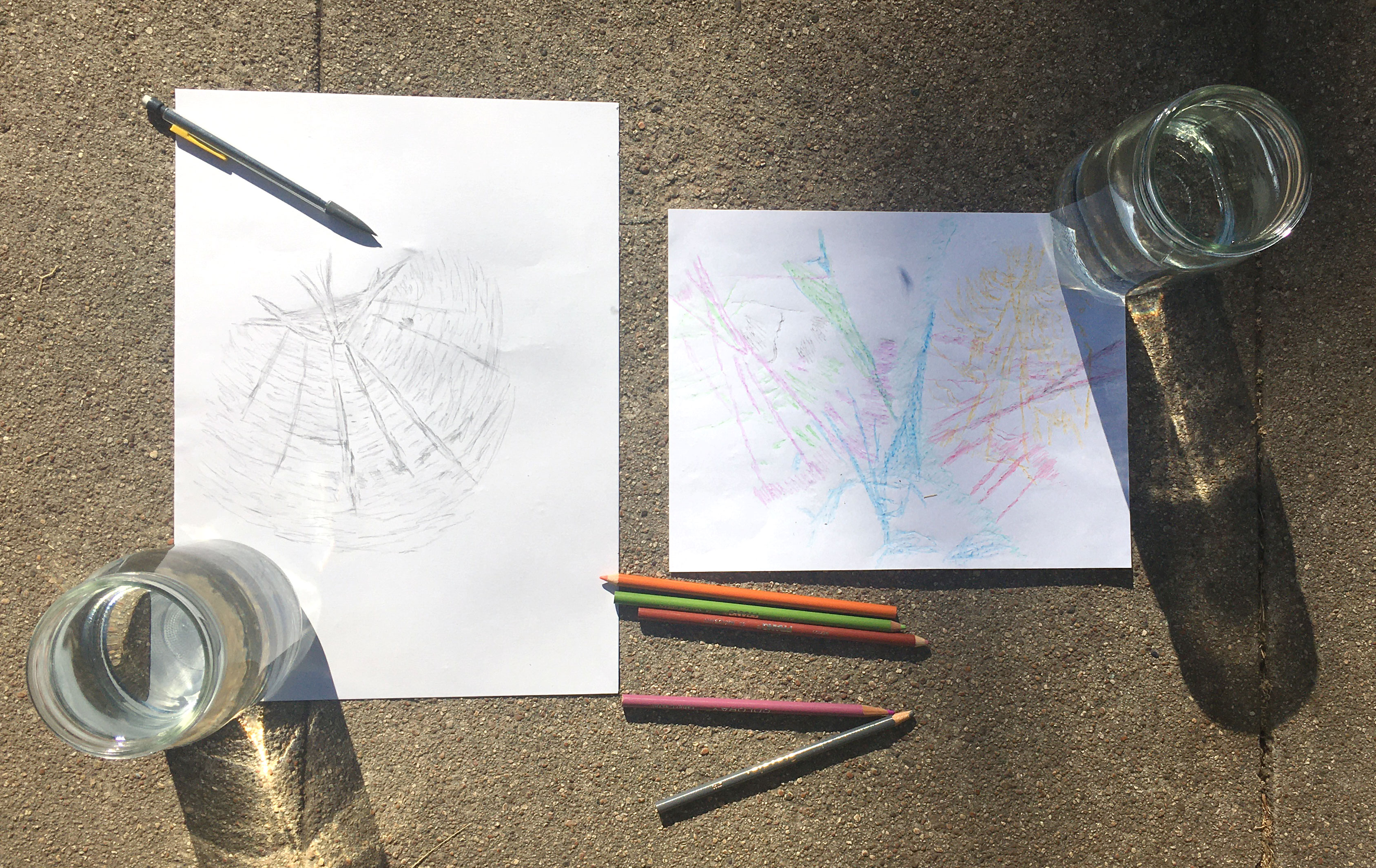 Artwork with colored pencils and regular pencil created by tracing the lines and shapes of sun shining through a water filled glass.