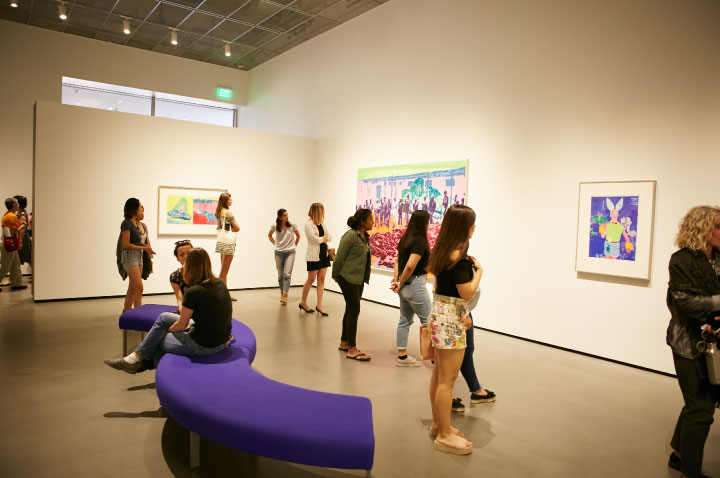 Photo of students in the galleries looking at art.
