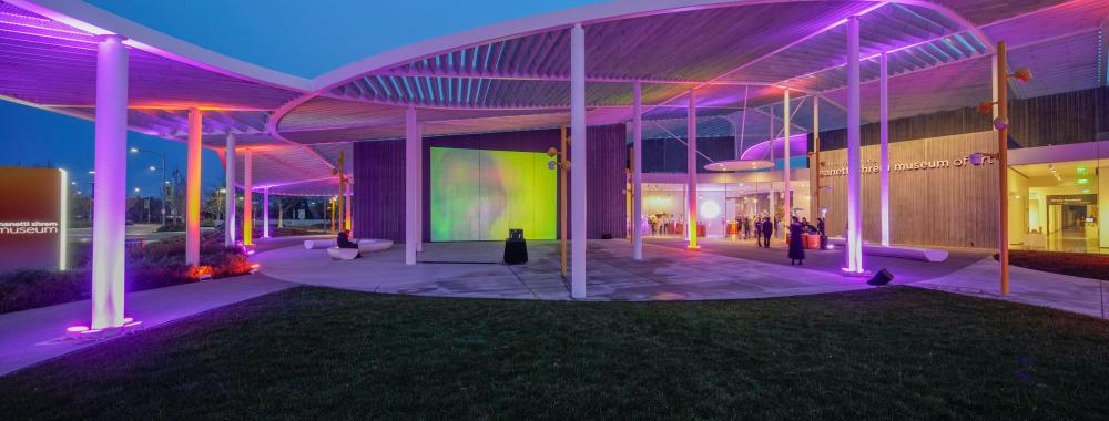 Museum canopy lit in purple light for the gala event.